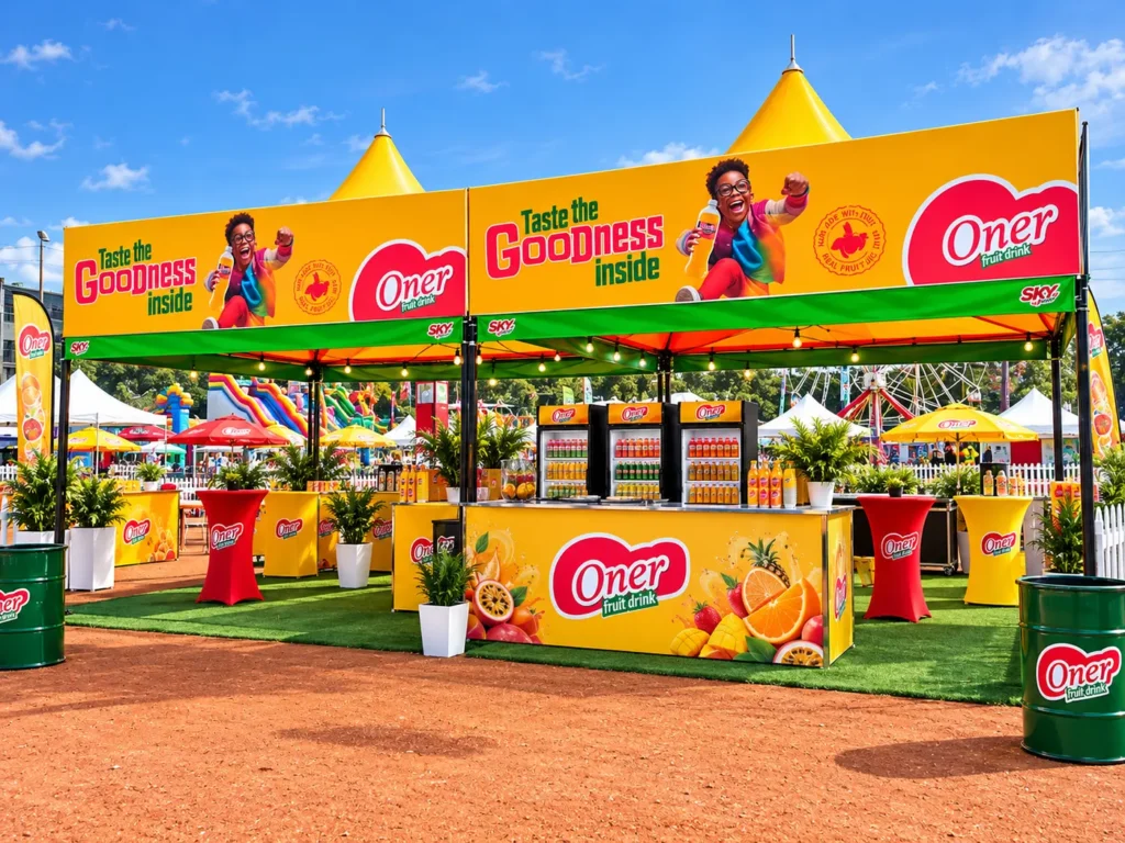 Rendered Oner fruit drink event stand with printed canopy banners, counter, flags and branded tables