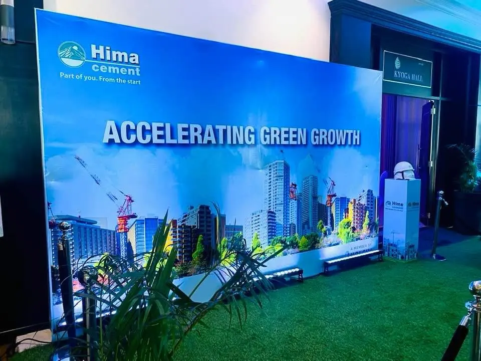 Blue event backdrop reading Accelerating Green Growth for Hima Cement