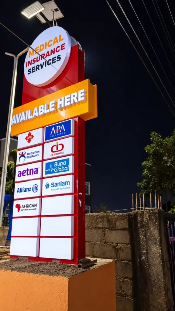 Illuminated roadside pylon sign at night